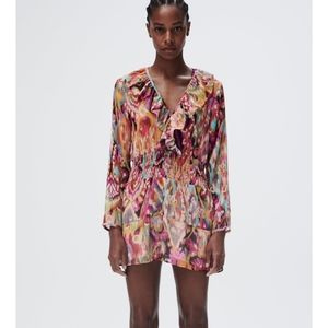 Sold out mini dress with ruffled V neckline and long sleeves. Elastic waist.